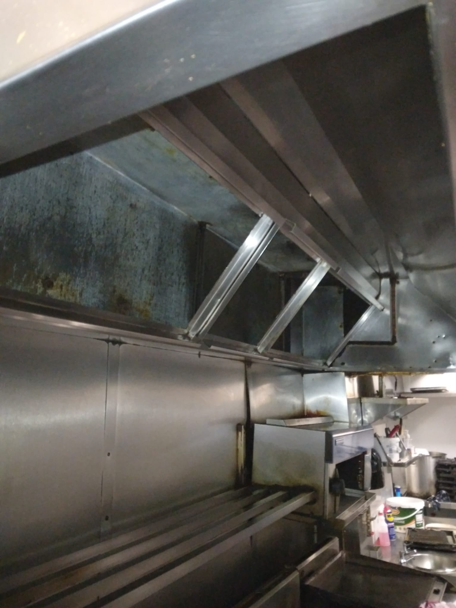 Commercial kitchen hood covered in dirt and grime